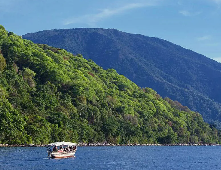 Boat along the Mahale Mountains shoreline on Lake Tanganyika